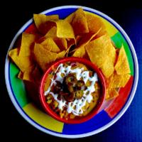Layered Bean Dip Dinner · Refried beans, enchilada sauce, Jack cheese, Cheddar cheese, guacamole and pico de gallo. To...