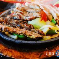 Fajita Sampler · Steak, chicken and shrimp. Served sizzling over a bed of sauteed onions and green peppers. A...