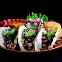 Tacos Autenticos Dinner · 3 tacos made with corn tortillas, charbroiled steak or chicken, finished with white onions, ...