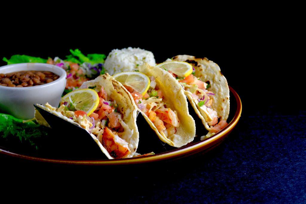 Shrimp Tacos Dinner · 3 shrimp tacos served mojo de ajo style and finished with cabbage, pico de gallo and Azteca's Chipotle Ranch sauce. Served with choice of rice and beans.