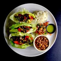 Vegan Lettuce Wraps Dinner · Iceberg lettuce halves filled with roasted vegetables, roasted corn and black bean salsa, se...