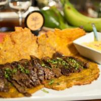 Rio Manzanares · Patacon topped with beef or chicken slices, and pineapple sauce.