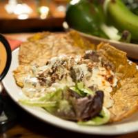 Sierra Nevada · Patacon topped with small pieces of beef or chicken, covered with mushroom sauce, and mozzar...