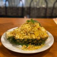 27. Pineapple Fried Rice · Fried rice with pineapple chucks, baby shrimp, chicken and a touch of yellow curry. Served i...