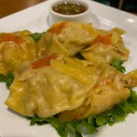 7. Steamed Dumpling · Steamed dumpling stuffed with chicken, shrimp and chopped ginger, served with spicy dark sau...