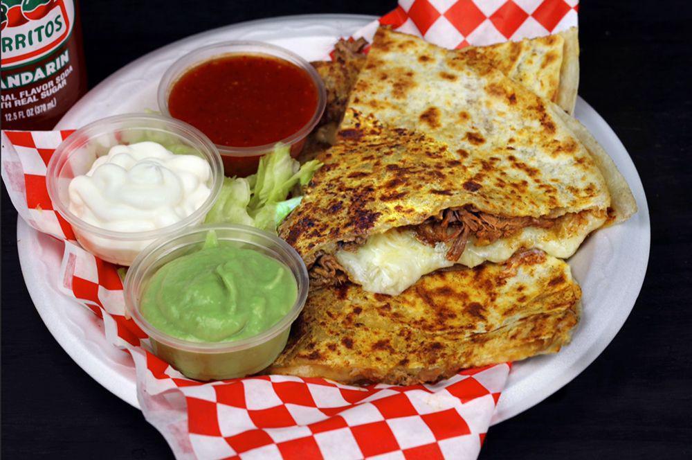 Quesadilla · Fresh flour tortilla sutffed with melted mix cheese, tomatoes and green onions. topped with sour cream and guacamole.