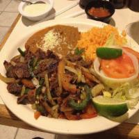 Bistec a la Mexicana · Steak cooked with Mexican sauce, jalapeno pepper, onion, tomatoes, rice, beans, and tortillas.