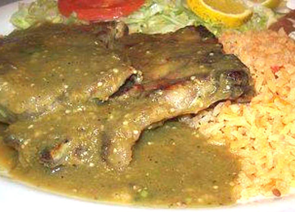 Chuletas de Puerco · Juicy cut pork chops marinated with Mexican spices and tomatillo sauce, served with rice, refried beans, pico de gallo, and sour cream.