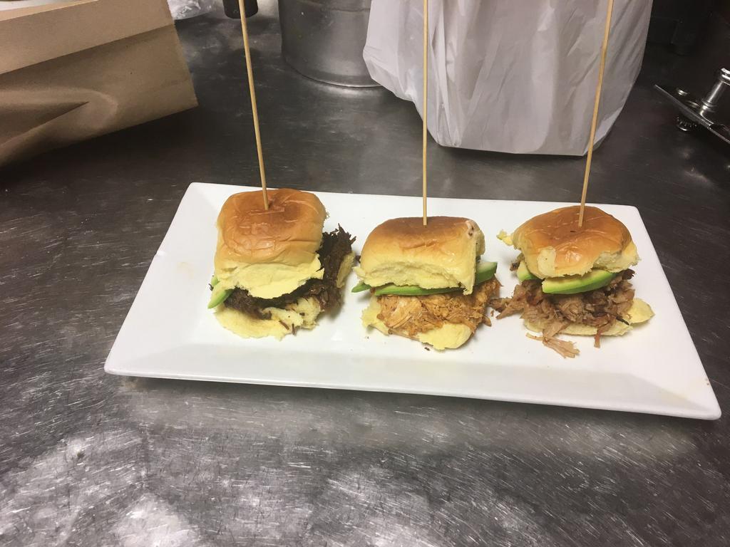 Sliders · One each of Tinga de Pollo (chiptole chicken), Barbacoa de Res (braised beef), Carnitas (pulled pork) topped with avocado & chipotle mayonaisse