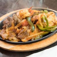 Sizzling Fajitas · Sauteed with onions, bell peppers and tomatoes served on sizzling plate with rice, beans wit...