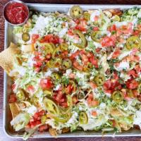 Nacho Tray Appetizer · Crispy corn tortilla chips spread thin on a baking sheet pan. Smothered with chicken tinga, ...