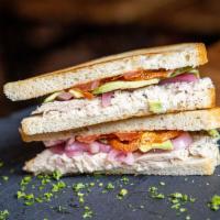 Tuna Avocado Sandwich · Tuna salad with tomatoes, avocado slices, pickled onions, with mayonnaise drizzle on toasted...
