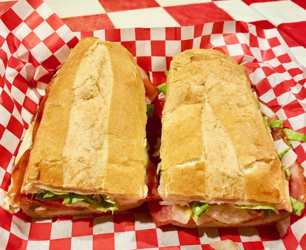 Italian Sub · Served hot or cold with sliced salami, ham, pepperoni, provolone, lettuce, tomatoes, white onions, mayo and mustard, drizzled with our homemade vinaigrette dressing. Served with a pickle and chips on a fresh hoagie roll.
