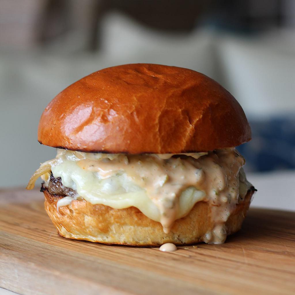 Smashed Burger · Prime dry aged beef blend, aged white cheddar, carmelized onions, special sauce, brioche bun.