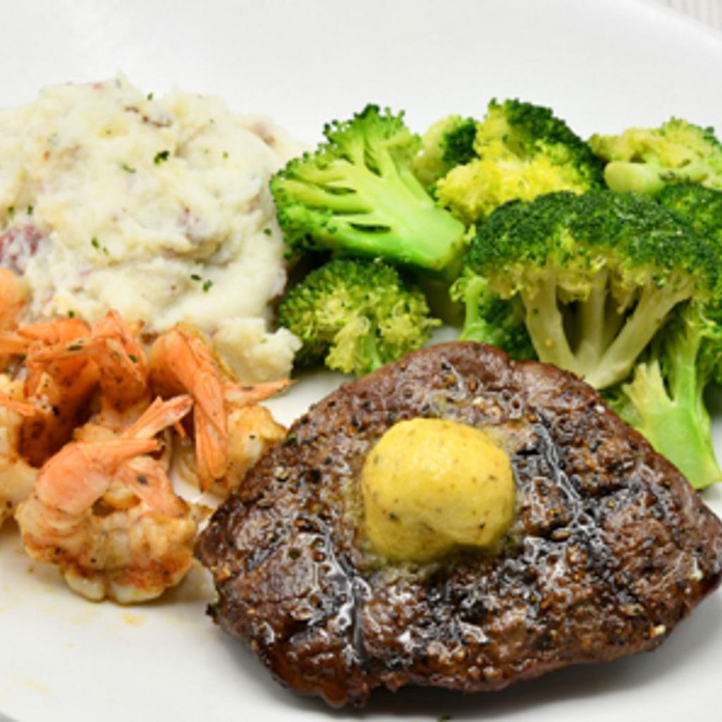 Land And Sea · 8oz. USDA Choice Top Sirloin topped with garlic butter, grilled shrimp skewer. Served over mashed potatoes and seasonal vegetables.