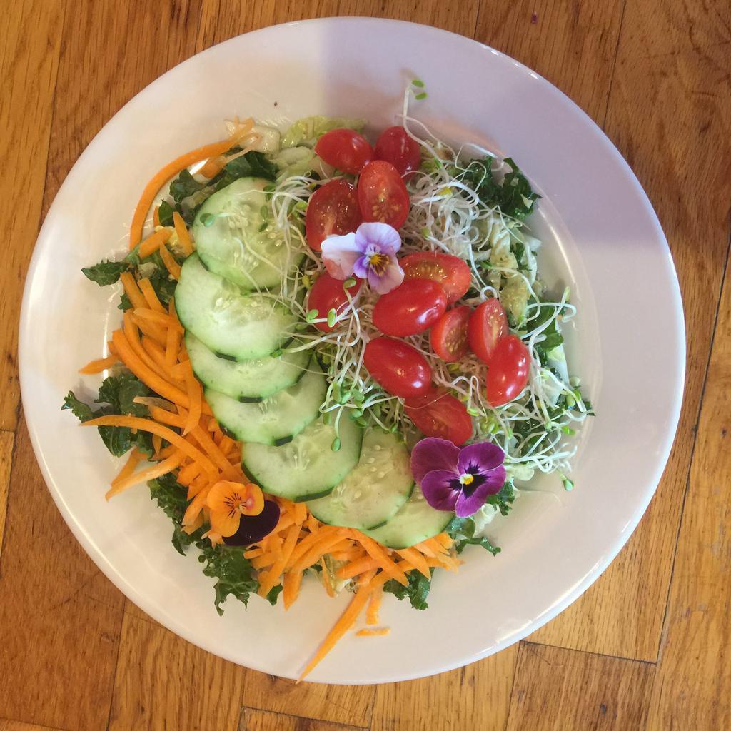 Green Salad  · Mixed greens, lemon chia dressing, carrots, cucumbers, pickled red onion, sprouts and sesame seeds.