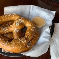 2 Bavarian Pretzels · Two large oven baked Bavarian -style pretzels served with a side of our homemade Queso chees...