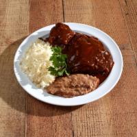 Mole Poblano · Thick, rich, chocolate-tinged sauce served over rice, chicken, refried beans and a salad.
