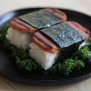 Spam Musubi ( 2 ) · Teriyaki glazed pan seared spam on top of sushi rice, wrapped in seaweed.