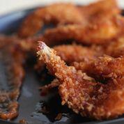 Crispy Coconut Shrimp · Golden, sweet, crispy coconut crusted shrimp served with our sweet and spicy pineapple sauce.