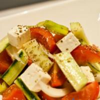 Horiatiki Salad  · Vine ripe tomatoes, feta, cucumbers, onions, olives, and peppers. Served with a warm pita.