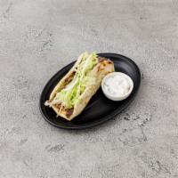 Gyro Sandwich · Lamb and beef seasoned with fresh herbs and roasted on a rotisserie. Served on pita bread wi...