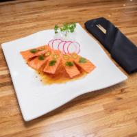 CA8. Salmon Carpaccio · Delicately cut salmon topped with slices of serrano pepper and cilantro, served in Japanese ...