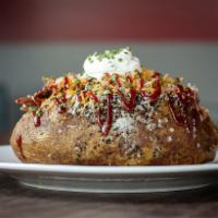 Loaded BBQ Potato · Choice of pork BBQ, smoked chicken, or beef brisket. Topped with butter, sour cream, salt, p...