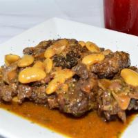 Oxtail and Butter Beans · Deliciously seasoned with the herbs and spices of Jamaica and slowly cook with butter beans.
