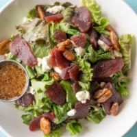 Apple Pecan Salad · Red wine poached apples, organic greens, Texas goat cheese and candied pecans with house hon...
