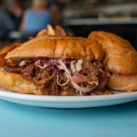 BBQ Brisket Sandwich · Texas grass fed brisket, pickled red onion, cabbage slaw, with tangy house BBQ sauce on boli...