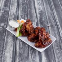 Bone-In Wings · Our classic, and most popular wings are baked twice until golden and crispy then tossed in y...