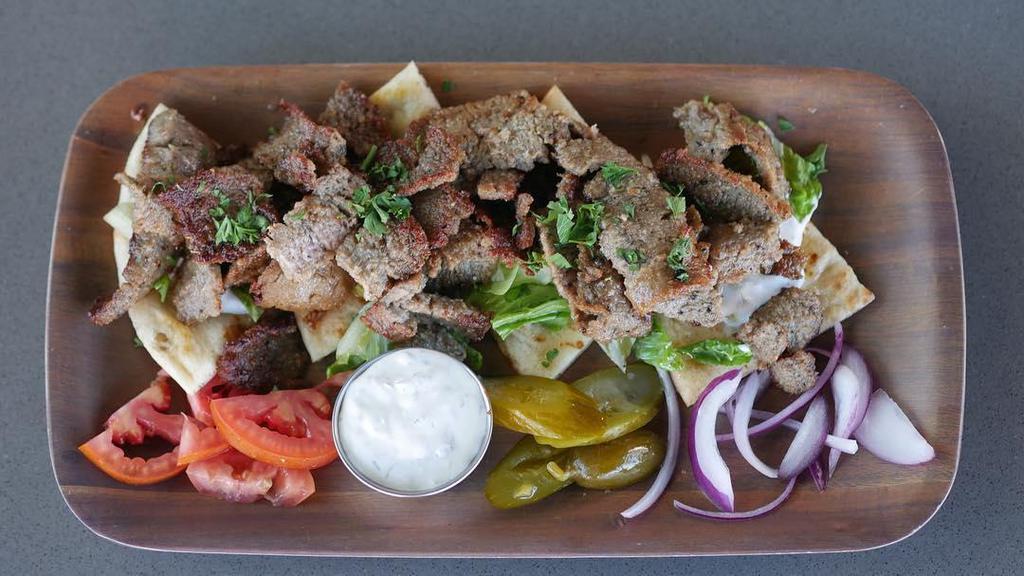 Open Face Gyros · Vertical rotisserie of beef and lamb, lettuce, tomato, onion, pickles, tzatziki, and pita.