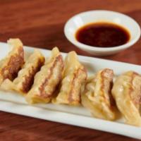 Pork Gyoza. · Pan-fried pork served with gyoza sauce.