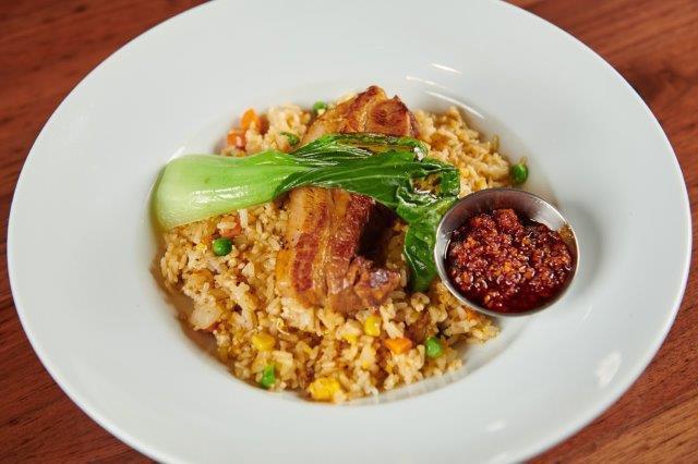 Pork Chashu Fried Rice. · Pork Chashu, Rice, Egg, Mixed Veggies, Sesame Seeds, and grilled Baby Bok Choy with Fried Chili Oil on the side.