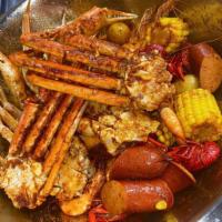 The Lick Bucket · 1/2 lb. clams, 1 lb. crawfish, 1 lb. snow crab, 1/2 head on shrimp, 4 corns, 4 potatoes. 