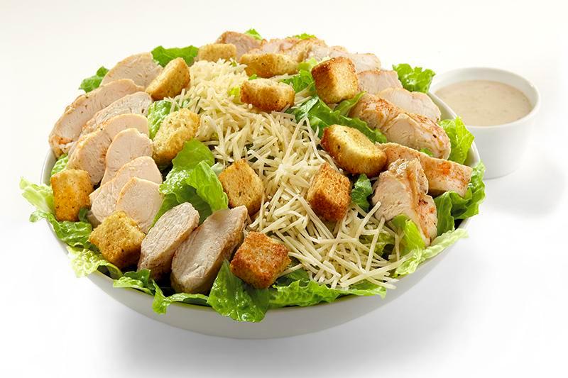 Chicken Caesar Salad (Family (Serves 4-6)) · The Classic Caesar of romaine lettuce, parmesan and croutons topped with tender chicken strips.  Pair with our Caesar dressing or pick from our list of dressing options.