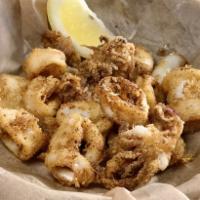 Salt and Pepper Calamari · Coated in our house blend seasoning and fried golden with lime aioli and chili cilantro sauce.