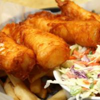 Beer Battered Fish and Chips · Fried Alaskan cod with tartar sauce and a lemon wedge.