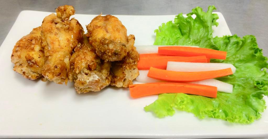 A6. Caramelized Chicken Wings · Deep fried wings tossed in fried garlic and caramelized fish sauce.