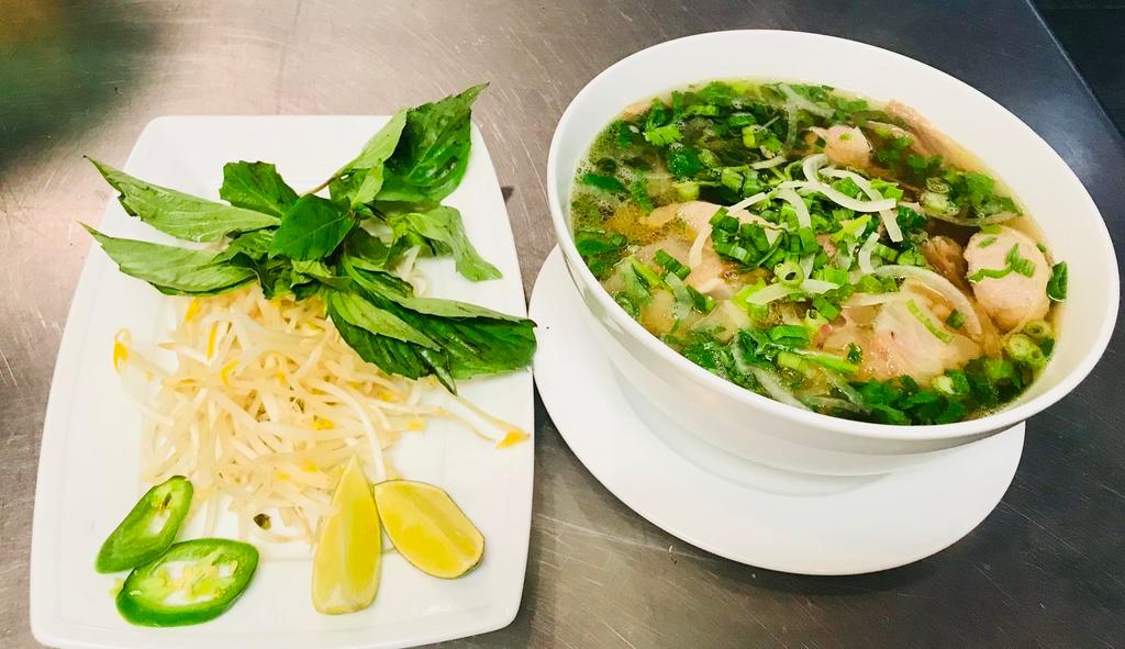 P3. Pho Ga · Pho with chicken. Includes broth, flat rice noodles, garnished with mixed onions, cilantro and served with bean sprout, basil, lime wedge and slices of jalapenos on the side. Gluten free.