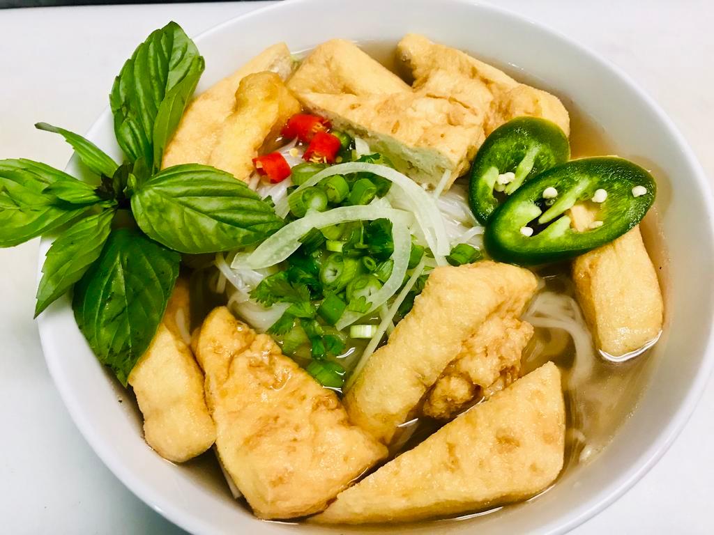 P5. Pho Tofu · Pho with tofu. Includes broth, flat rice noodles, garnished with mixed onions, cilantro and served with bean sprout, basil, lime wedge and slices of jalapenos on the side. Gluten free.