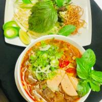 F4. Bun Bo Hue · Spicy beef noodle soup with round rice noodles, beef brisket and shank, tendon, pork sausage...