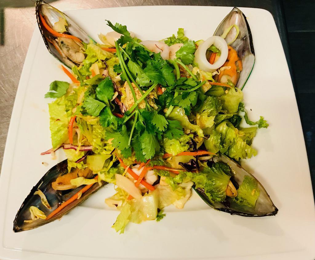 S6. Goi Do Bien · Seafood salad. Shrimp, scallop, squid, mussel and green lettuce tossed in lime vinaigrette.