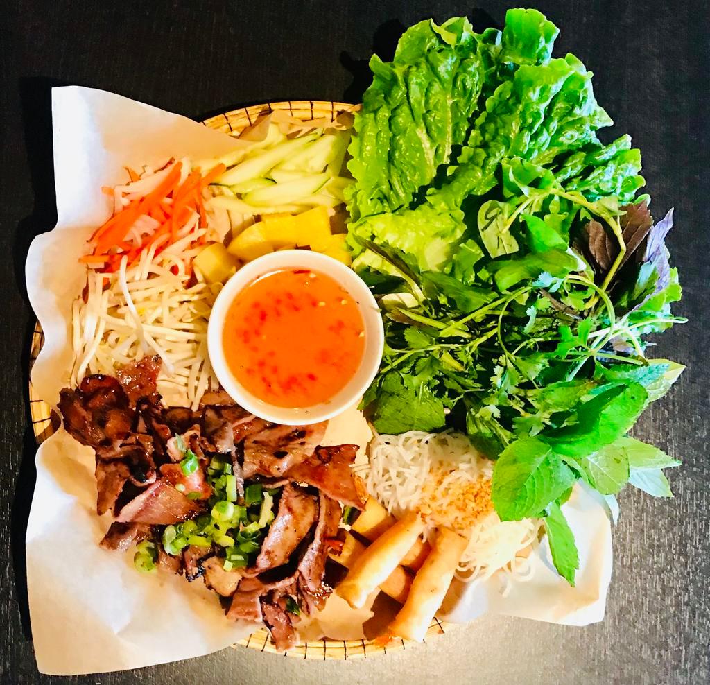 D2. Thit Nuong Cha Ram Platter · Grilled marinated thin sliced pork and crispy shrimp rolls. Includes assorted herbs and vegetables, rice, vermicelli noodles, rice paper and house dipping sauce.
