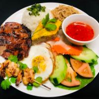 R8. Com Dac Biet Plate · Combination. Charbroiled pork chop, shrimp, skewer, pork skin, pork-egg custard and fried eg...
