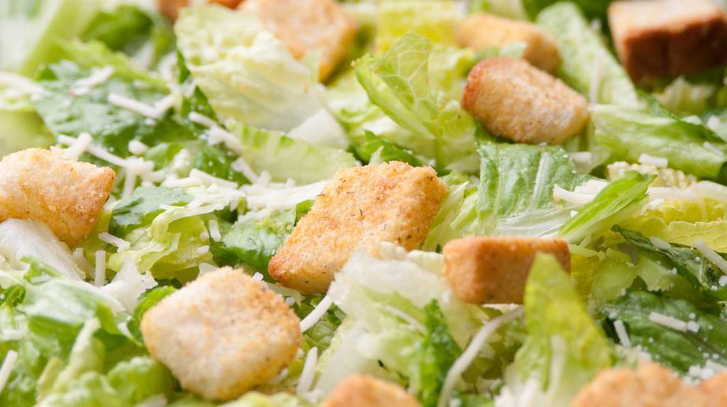 Caesar Salad · Fresh romaine lettuce topped with shredded Parmesan cheese, croutons and Caesar dressing.
