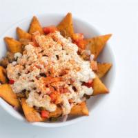 Greek Nachos · Fried pita chips topped with choice of protein, tomatoes, onions, sauteed bell peppers, hous...