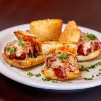 Meatball Sliders · Four sliders topped with marinara sauce, melted mozzarella and basil. Baked on our own passi...