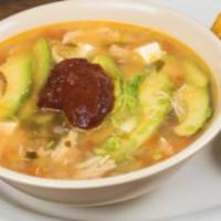 Caldo Tlalpeno · Chicken broth, chicken, chipotle pepper, avocado and queso fresco. Served with rice and flou...